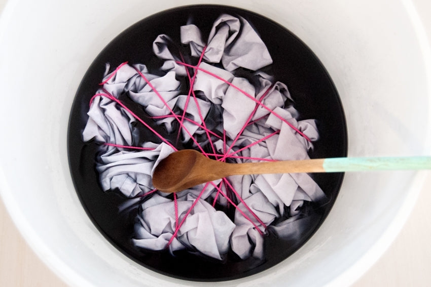 Submerge fabric in dye
