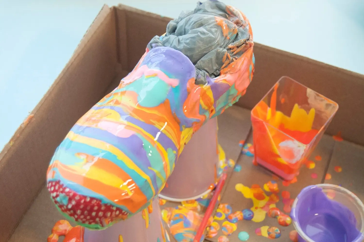 Keep alternating pouring paints until shoes are covered