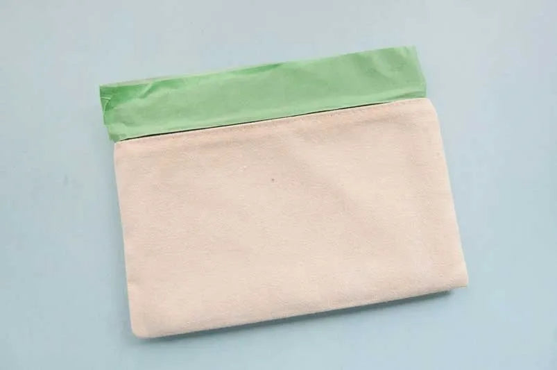 Place cardboard into pouch and tape off zipper