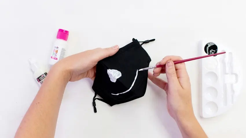 Use fabric paint to decorate your skeleton mask