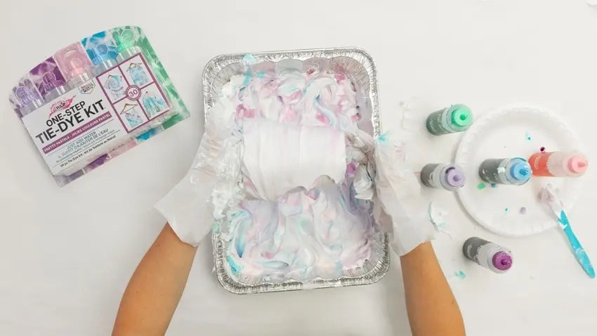 Apply dye to shaving cream and create marbled patterns with knife