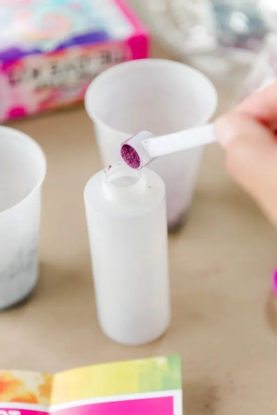 Scoop dye powder into bottles