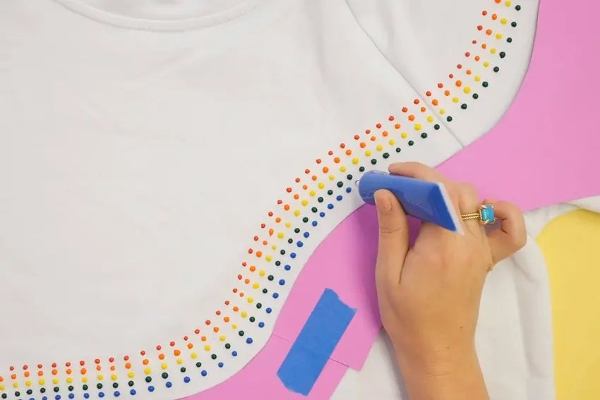 Step 3: Continue applying dot paint in a rainbow pattern