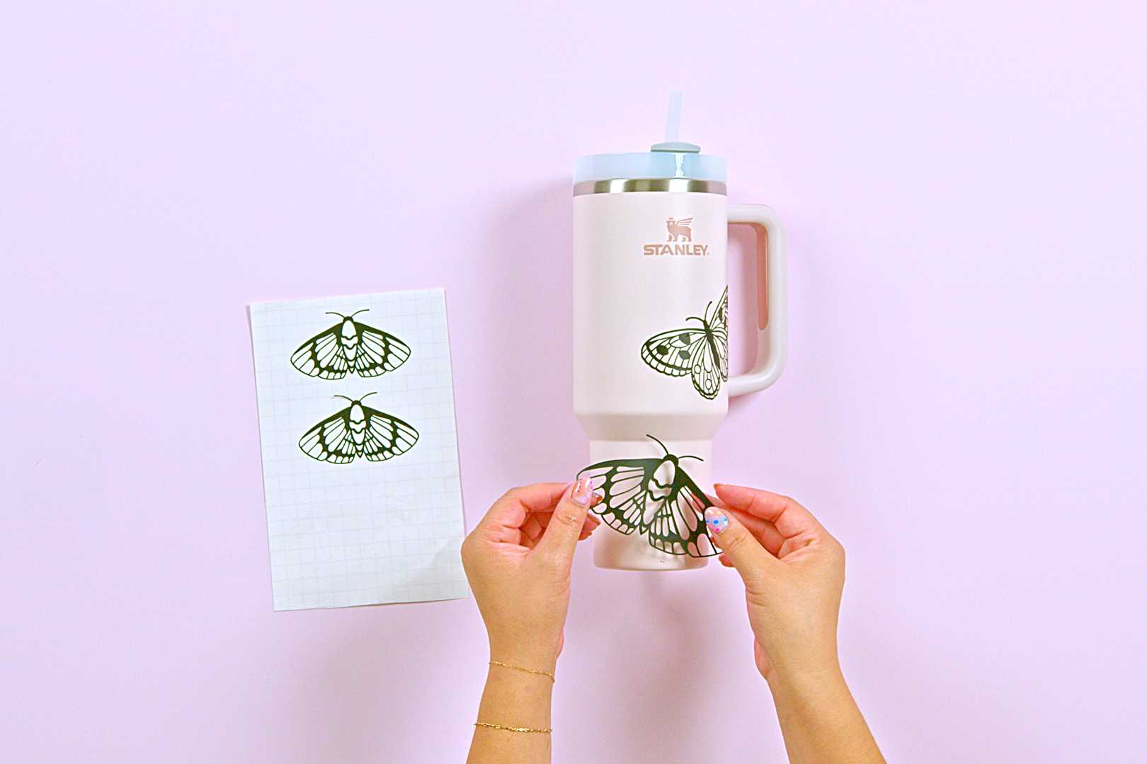 Prepare the tumbler cup and apply butterfly stencils