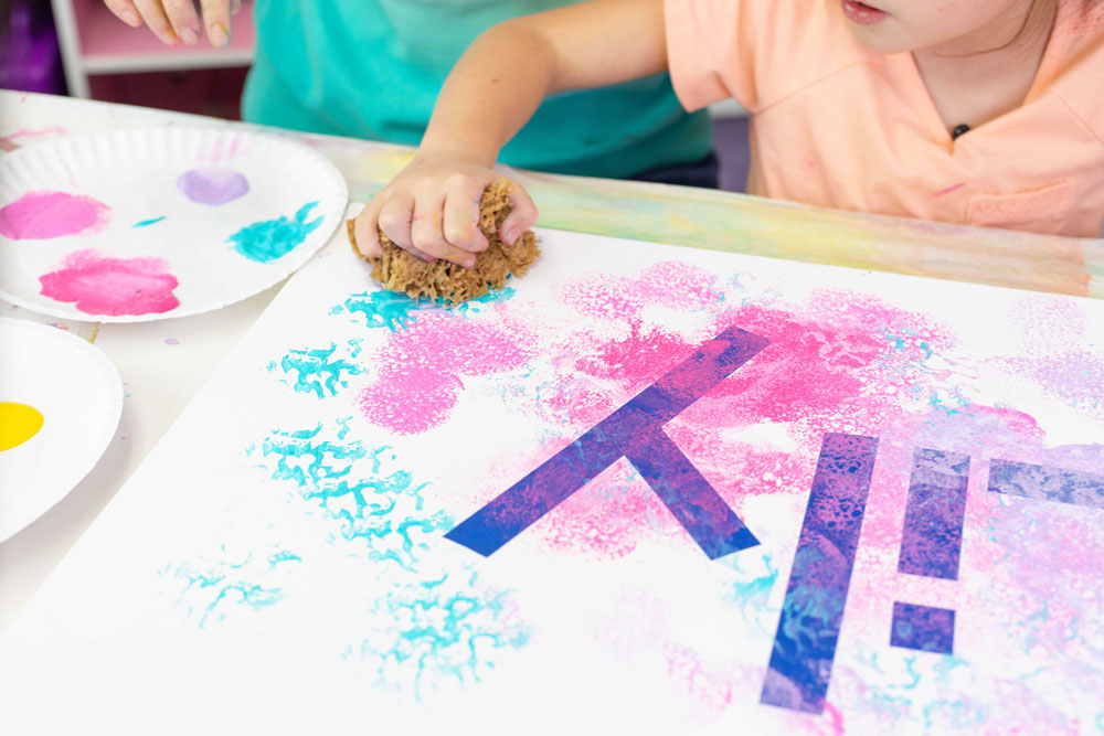 Use sponges to apply the paint to canvas