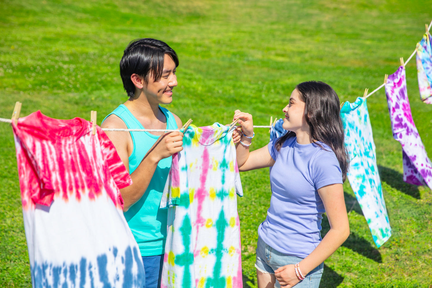 Completed tie-dye projects line drying outdoors