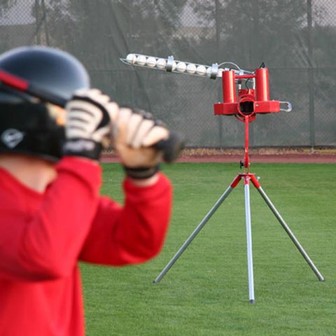 kid in red and pitching machine