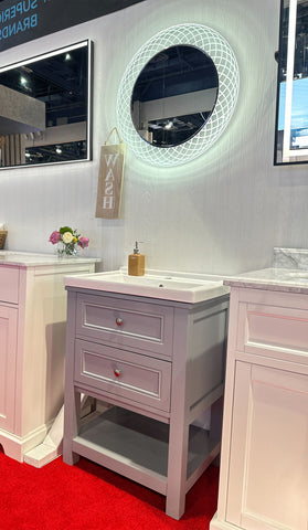 Modern bathroom vanity set with a LED bathroom mirror and floral decor on display at a showroom.