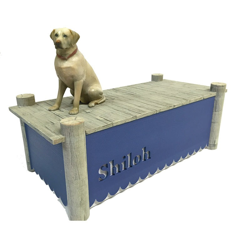 A custom ceramic pet urn that depicts a dog named Shiloh sitting on a dock