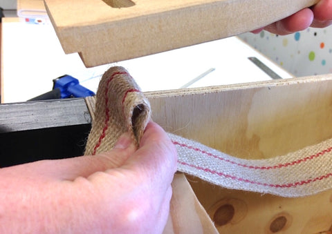 Using a web stretcher to install jute webbing on upholstery furniture chair
