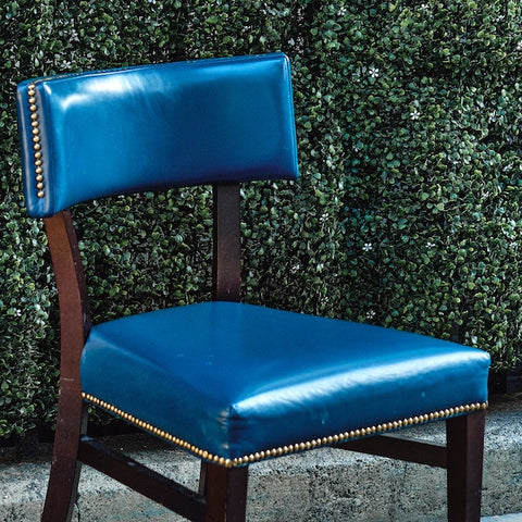 Blue chair with decorative nailhead trim