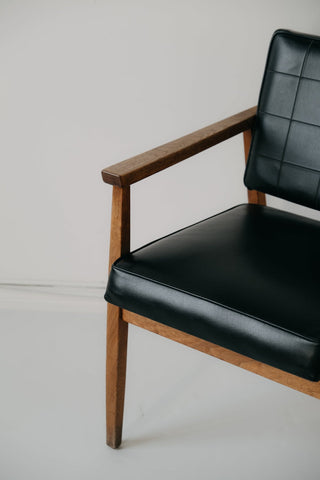 Black vinyl armchair with wooden arms