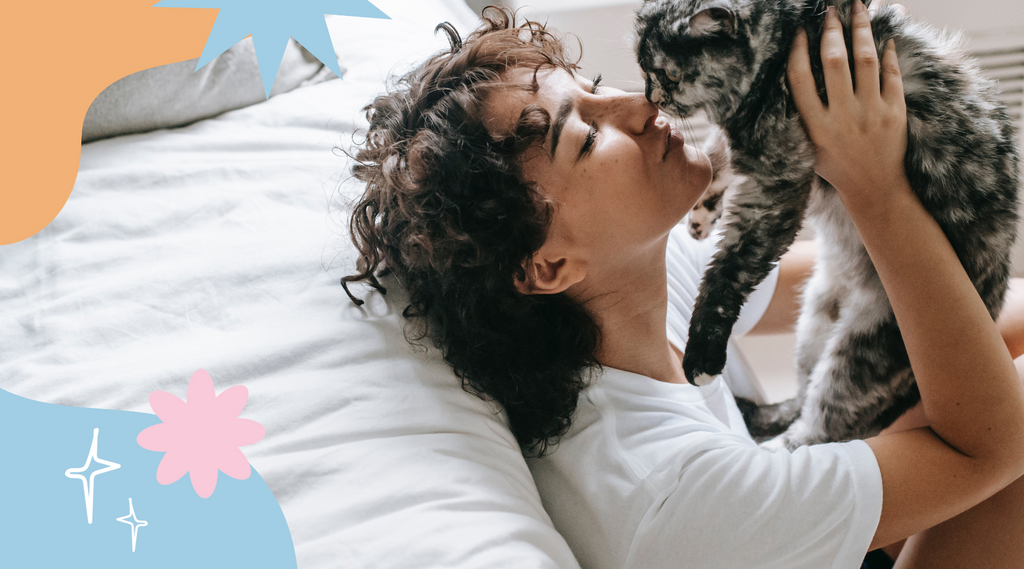 Happy woman cuddles and kisses a fluffy cat