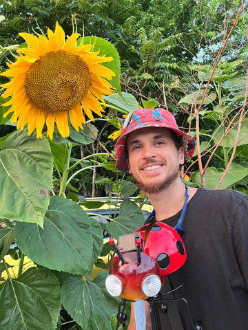my husband with a giant sunflower I planted
