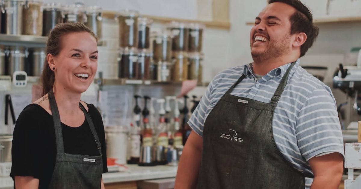 joyful employees wearing corporate gifting swag