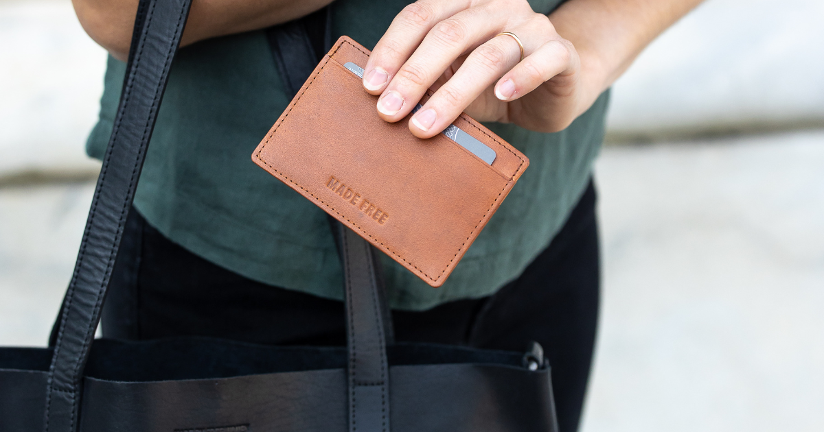 Woman carrying veg tanned leather card wallet