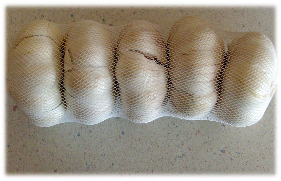 Grocery store garlic inside a mesh bag