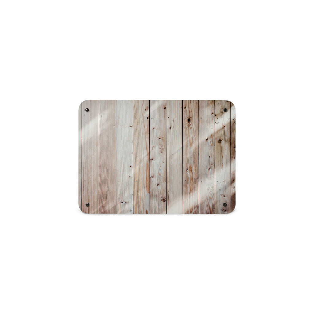 A small magnetic notice board or metal wall art panel depicting a photograph of planks of wood cladding