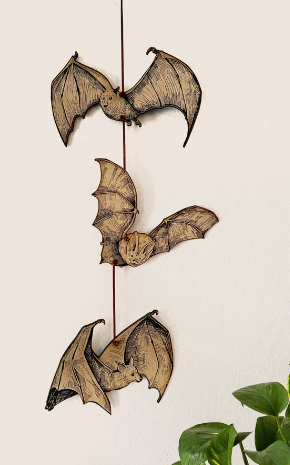 mobile of woodburned bats