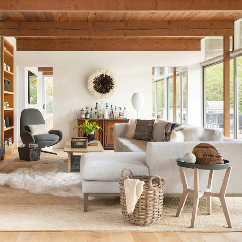 Serene Grey Kubu rattan wicker basket in a living room with lots of natural lighting.