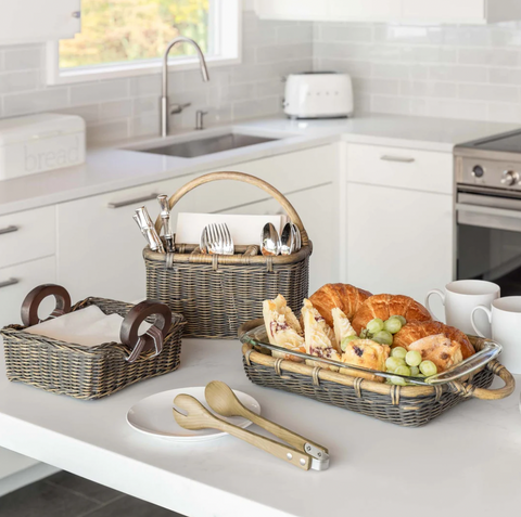 Kitchen counter with wicker casserole basket, wicker utensil caddy, and wicker napkin basket