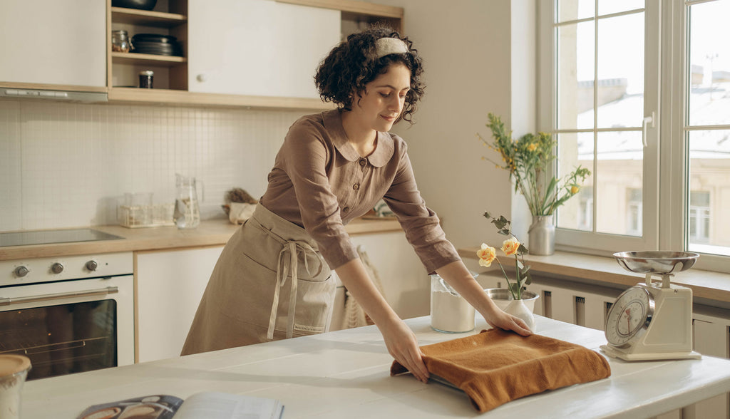 Woman Baking in a Rustic Farmhouse Kitchen, with vintage accessories.