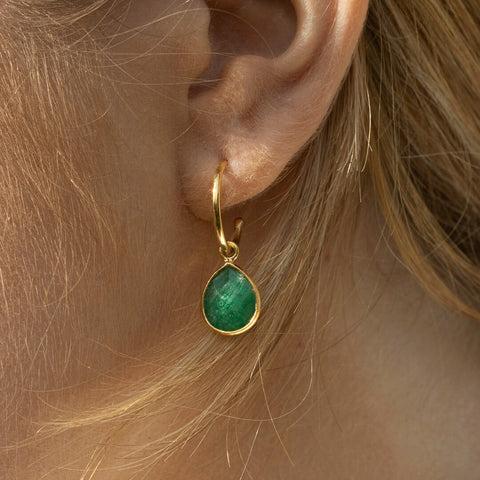 emerald hoop earring in gold on model