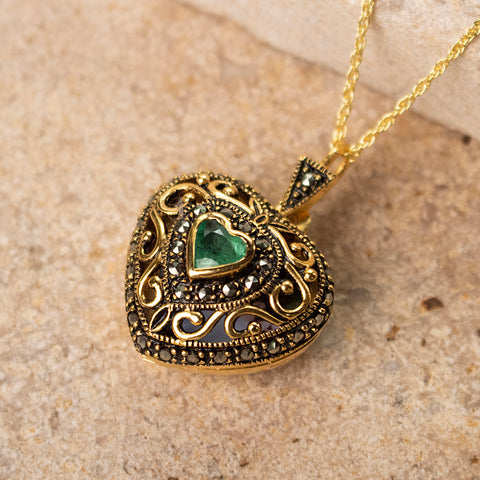 emerald locket in gold on a gold chain