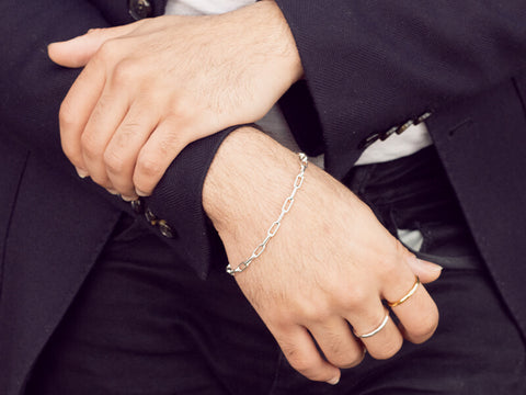 men's silver chain bracelet worn on a male model