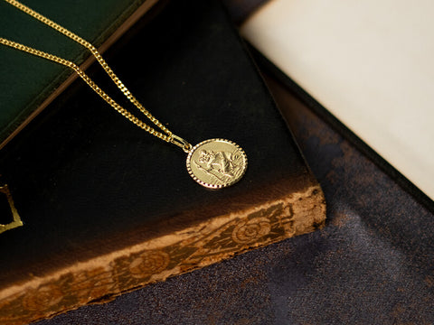 men's gold st Christopher necklace on leather book