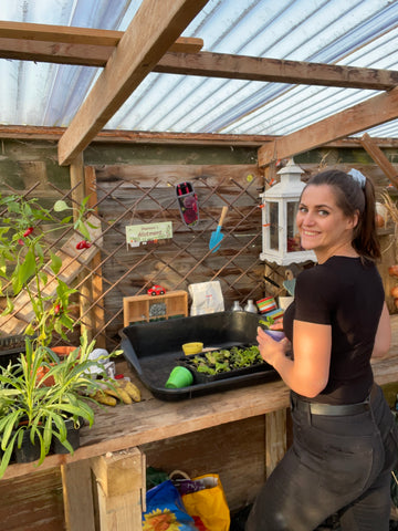 Shannon, The Lady Gardener, sowing seeds in her greenhouse