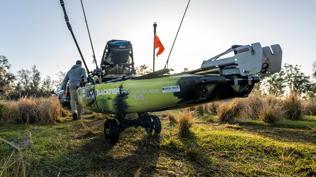 Man transporting kayak with C-Tug Kayak Cart