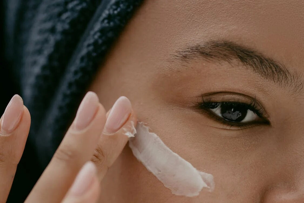 A woman applying eye cream