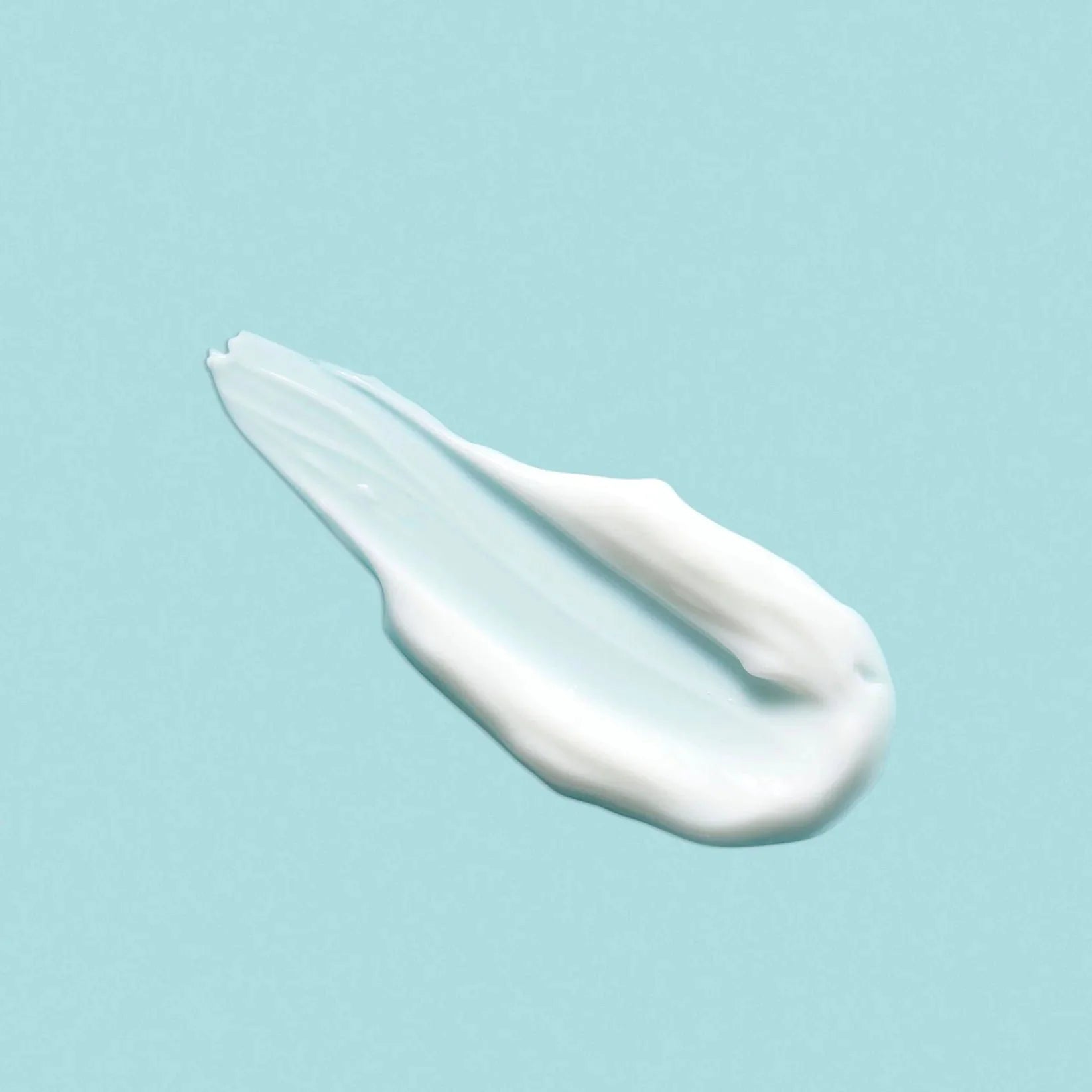 a swatch of moisturizer on a blue background