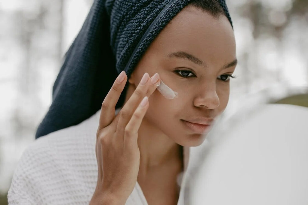 A woman applying moisturizer