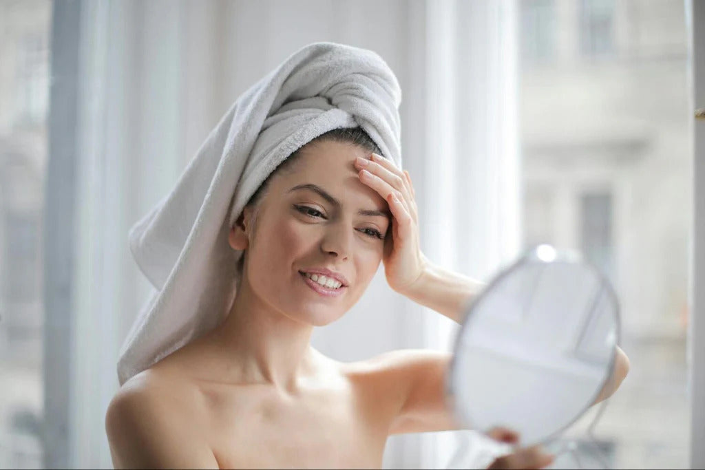 woman smiling looking in the mirror