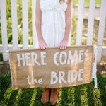 Flower girl holding sign