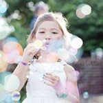 Flowergirl blowing bubbles