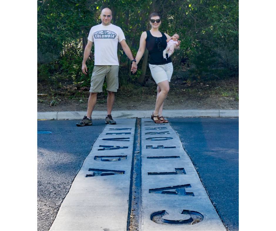 Couple with their baby holding hands on the Nevada and California state line in Lake Tahoe