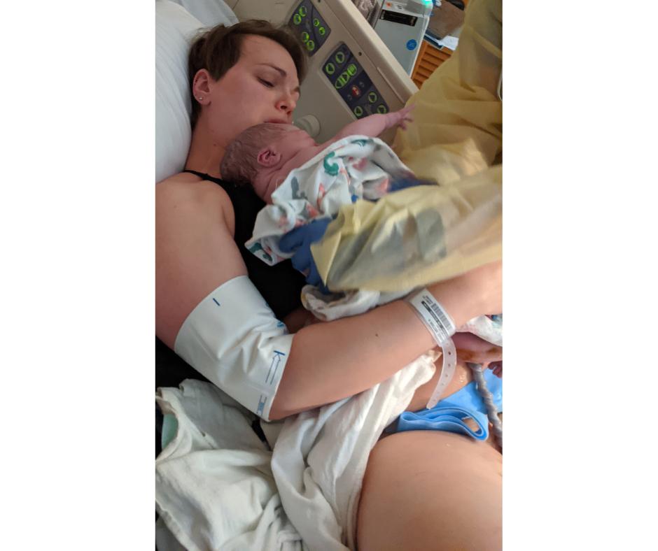 Mom emotionally holding her newborn baby just after birth in a hospital