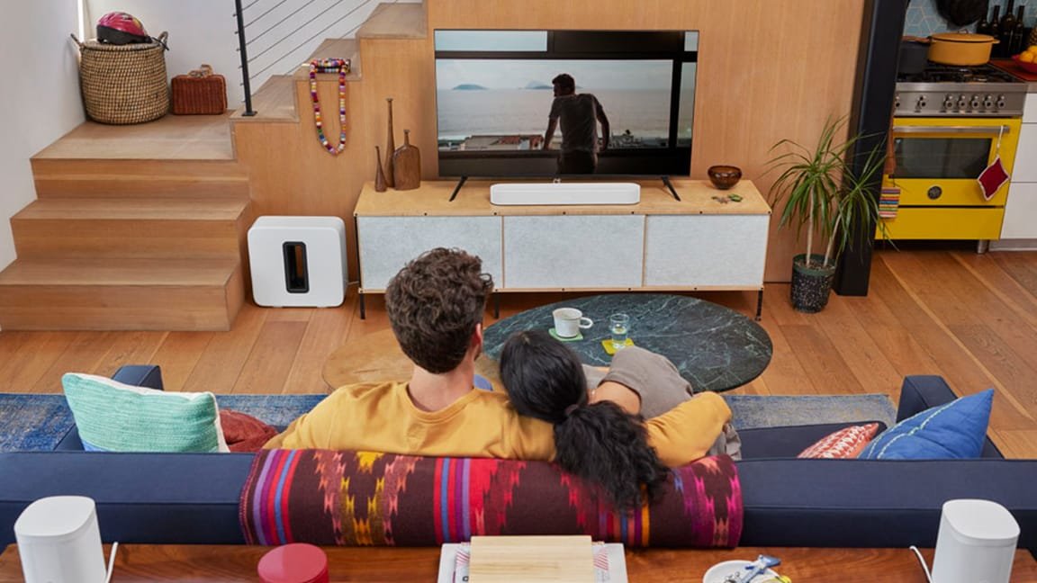 Couple watching movie with Sonos Beam Gen 2 and Sub Gen 3