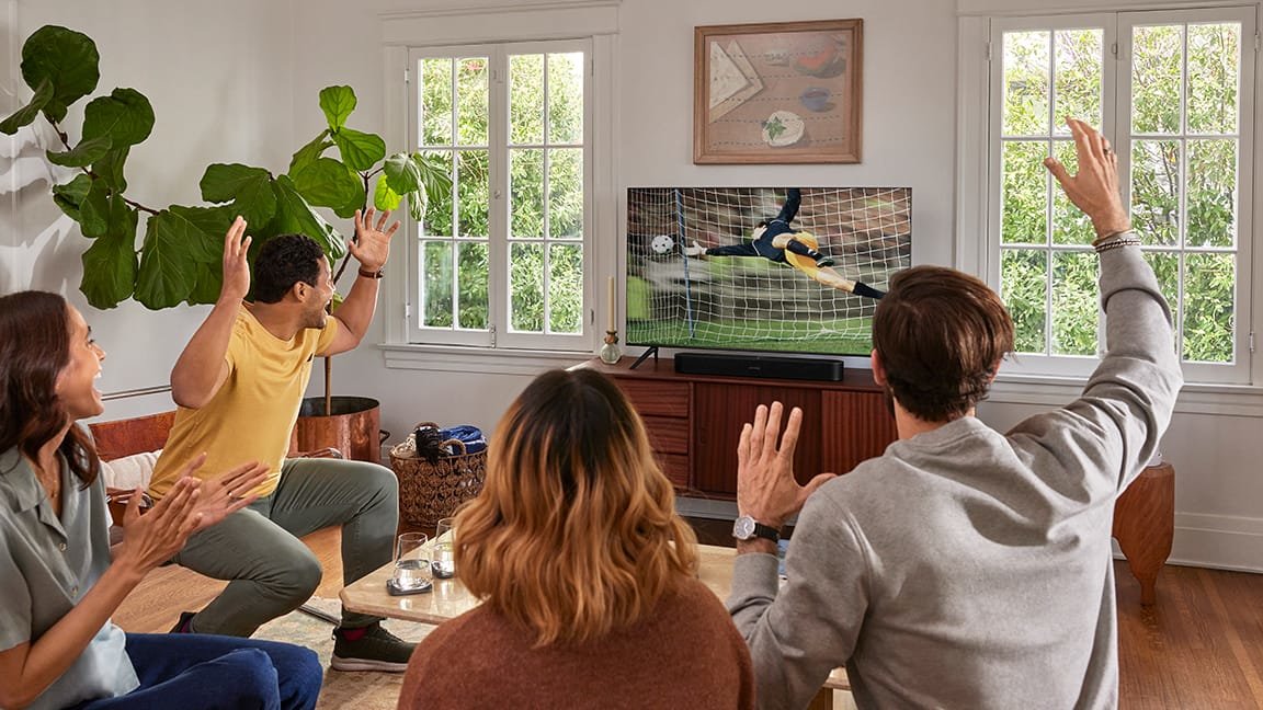 People watching soccer game on TV with Sonos Beam Gen 2 sound bar