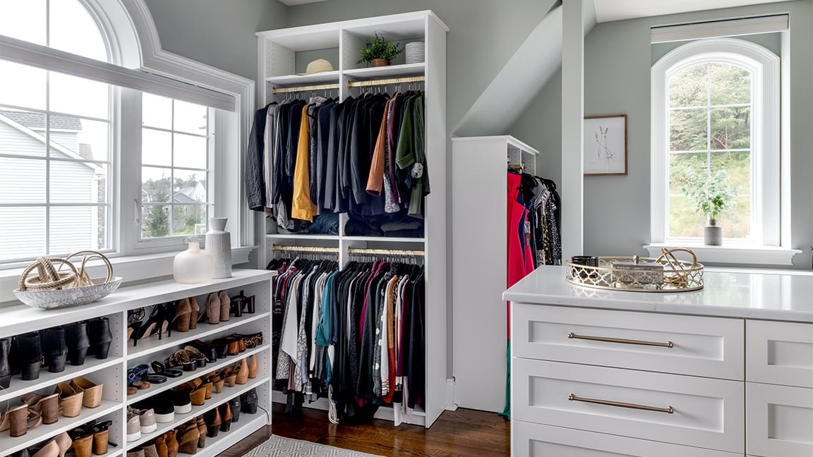 Closet with clothing organizers and Lutron shades