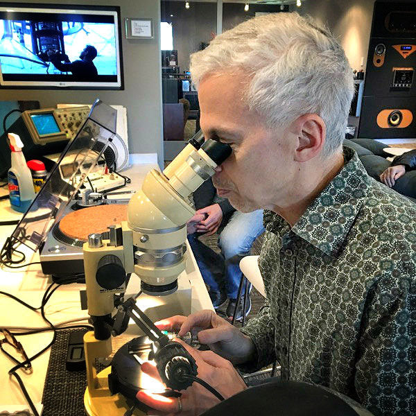 Ken diagnosing an issue with a microscope