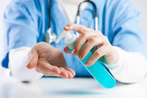 doctor applying hand sanitizer