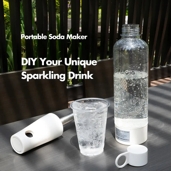 Asfolia's bush white portable sparkling water maker is placed on the table with a glass of sparkling water.