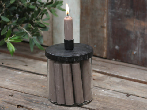 Scani Glass Candle Jar with short dinner candles on a wooden table with foliage