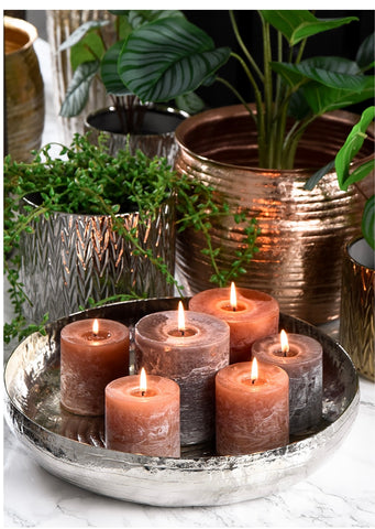 Metallic Bowl with candles and metallic plant pots with greenery