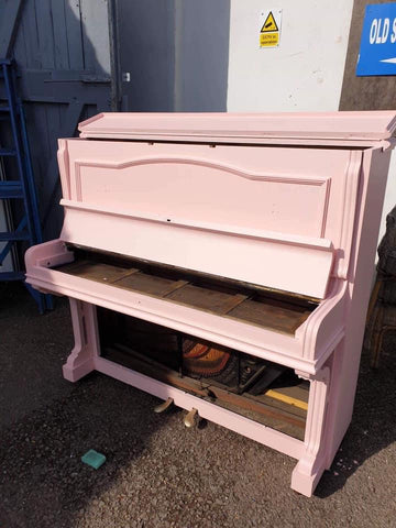 Old piano saved from landfill painted pink to be used as a planter