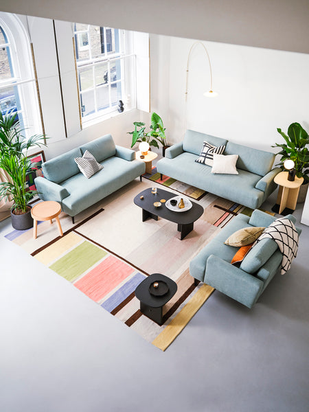 Birds eye view of living room with three sofas 